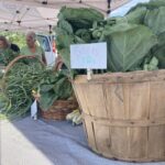 Baskets of spring veggies on a market table